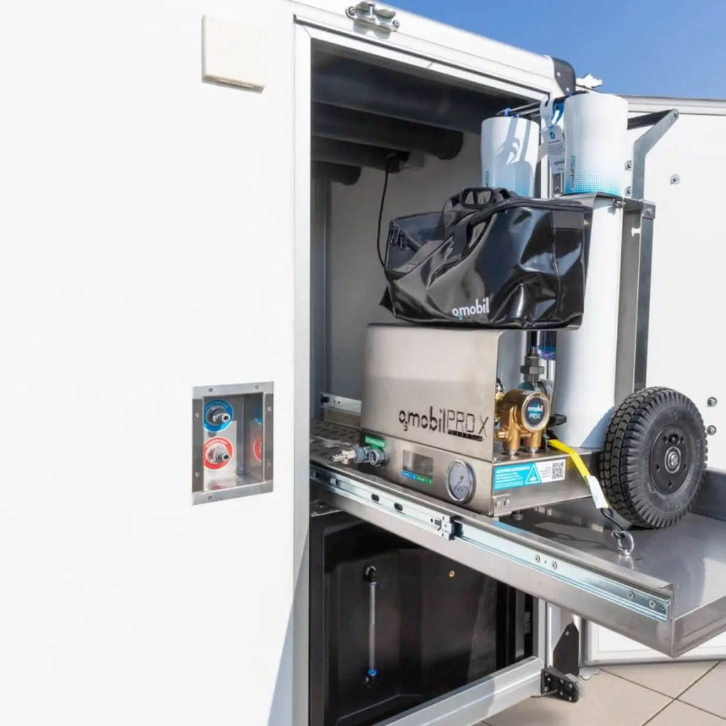 Silberne edelstahl qmobil pro x tragbare wasserpumpe mit messingarmaturen und schwarzer tasche auf osmobil trailer v2 anhängersystem